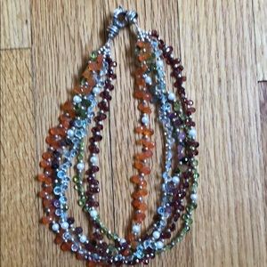 Multi-strand multi-gemstone necklace.